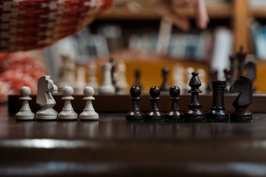 The Art of Drawing Readers In: Your attractive post title goes here Close-up of chess pieces on a chessboard highlighting strategic play indoors.