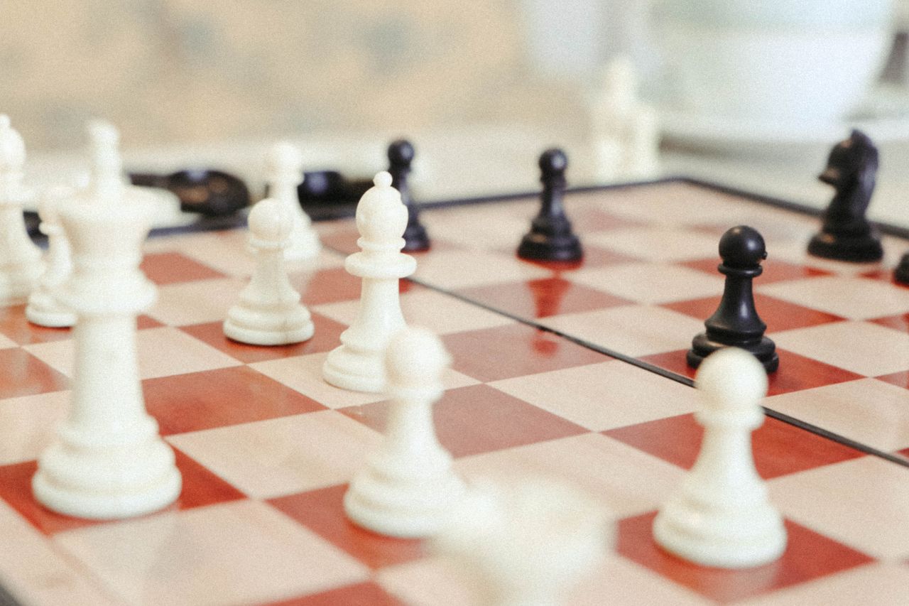 A detailed close-up of a chess game in progress with focus on the pieces.